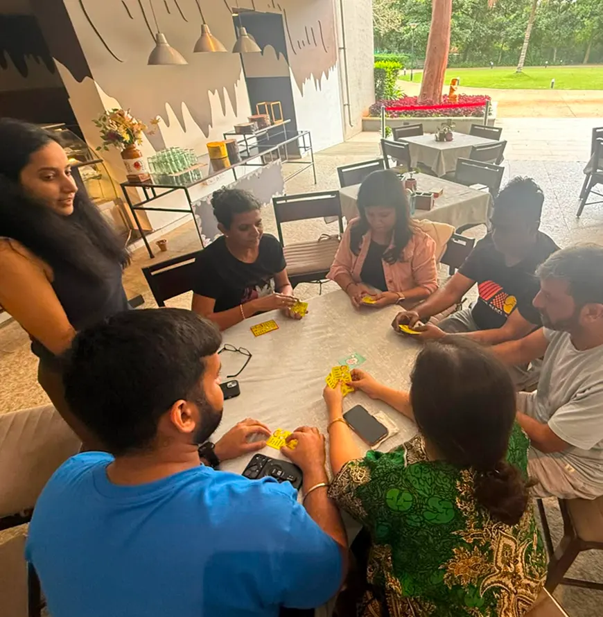 Colleagues playing a board game around a table