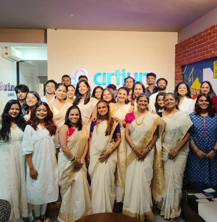 The team dressed for Onam in front of the Artium wall